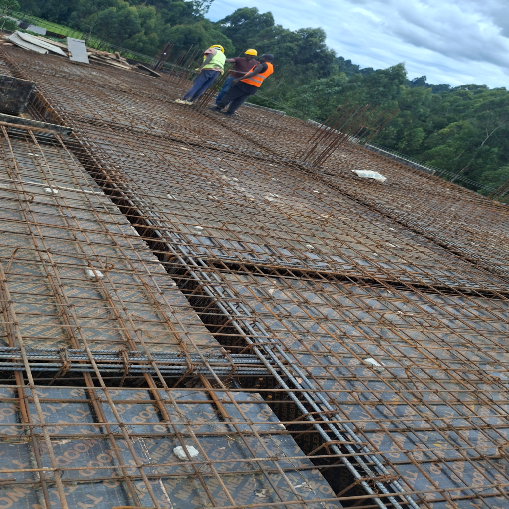 Engineers and project managers inspecting the steel rebar and formwork setup before a concrete slab pour